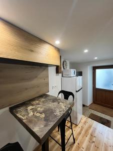 a kitchen with a table and a refrigerator at 18 m studio in Orelle 73140 in Orelle