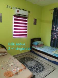 a small room with two beds and a window at TWIN TWO Homestay in Kepala Batas