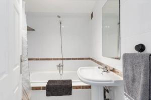 a white bathroom with a sink and a shower at Bahía Mar Apartamento in Puerto de Mazarrón +12 photos