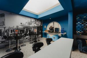 a room with blue walls and black chairs and a table at Gomila Palma Apartments in Palma de Mallorca +32 photos