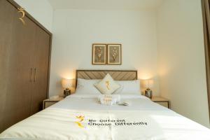 a bedroom with a bed with a sign on it at Al Raha Beach Elegant 2BR Apartment with Private Balcony in Abu Dhabi