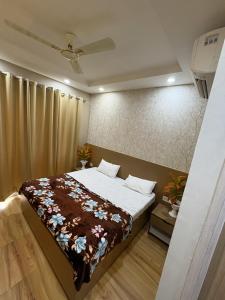 a bedroom with a bed with a brown blanket at Happy Stay expo in in Greater Noida
