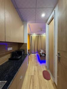 a room with a kitchen and a room with a bed at Happy Stay expo in in Greater Noida