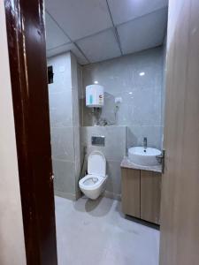 a small bathroom with a toilet and a sink at Happy Stay expo in in Greater Noida