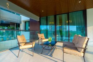 a lobby with two chairs and a glass table at Stylish 2BR Stay - Elegant Al Raha Haven Escape in Abu Dhabi