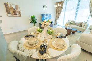 a dining room with a table and chairs at Al Raha Beach Elegant 2BR Apartment with Private Balcony in Abu Dhabi