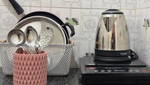 a toaster sitting on top of a counter next to a toaster at Swarga Fireflies Duo in Bengaluru