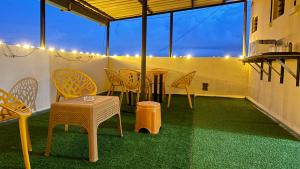 a patio with chairs and a table on a balcony at Swarga Fireflies Duo in Bengaluru