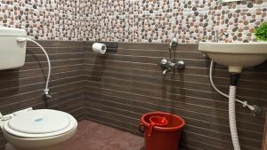 a bathroom with a toilet and a sink at Swarga Fireflies Duo in Bengaluru +24 photos