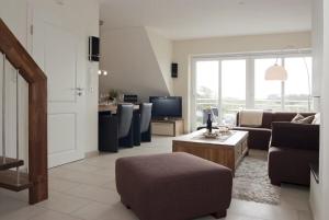 a living room with a couch and a table at Perle von Borkum 1 in Borkum +13 photos