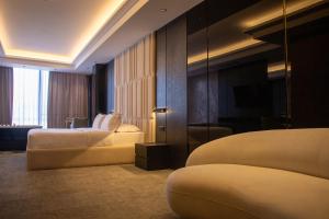 a hotel room with two beds and a mirror at Hotel Chicago in Shkodër