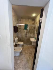 a bathroom with two toilets and a shower at Sossita Guesthouse & Boutique Resort 