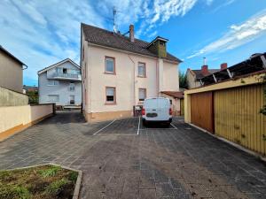 a van parked in a parking lot in front of a house at Villa Rumpenheim in Muhlheim am Main