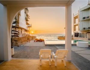 two chairs and a view of the ocean from a house at Sea Sand Sun Pool Villa cha-am in Cha Am +92 photos