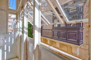 an empty building with a window and a balcony at Lovely 4BR Maltese Home with Private Garden & BBQ by 360 Estates in Cospicua