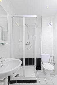 a bathroom with a shower and a toilet and a sink at Penzion Hendrych in Vrchlabí