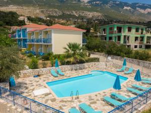 a view of the pool at a villa with a resort at Milos Studios in Lourdata