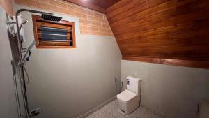 a small bathroom with a toilet and a window at Siri Villa Cabana Habaraduwa in Habaraduwa