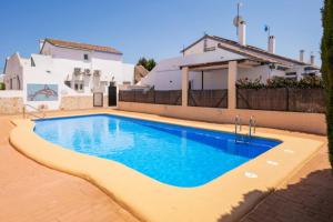 a swimming pool in front of a house at The Beach house in El Verger