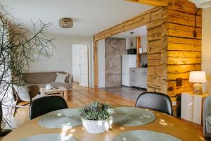 a living room with a table and chairs at Upės Namai Jonami in Anykščiai