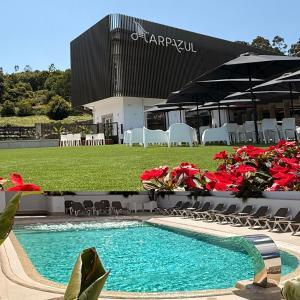 a swimming pool in front of a building at Harpazul in Catoira