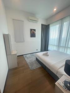 a bedroom with a large bed and a window at Opus Residences KL by SA in Kuala Lumpur