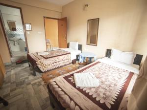 Cama ou camas em um quarto em Paundur Community Homestay