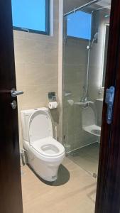 a bathroom with a white toilet and a shower at Colombo Trizen Luxury Apartment in Colombo