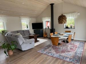 a living room with a table and a couch at Lake & Forest Escape in Skeinge in Osby