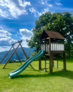 a playground with a slide and a gazebo at Casa Sperandini in San Marcello Pistoiese