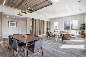 a living room with a wooden table and chairs at CozySuites AYR in Indianapolis