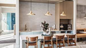 a kitchen with a dining table and chairs at CozySuites AYR in Indianapolis