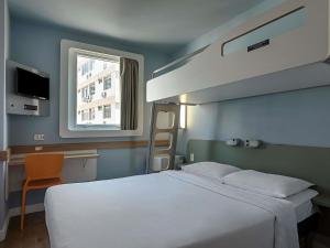 a bedroom with a large white bed and a window at ibis budget RJ Praia de Botafogo in Rio de Janeiro +66 photos