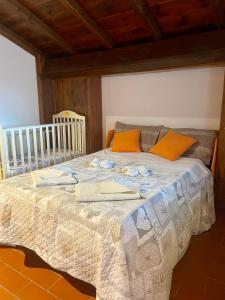 a bedroom with a large bed with orange pillows at Casa Sperandini in San Marcello Pistoiese +120 photos