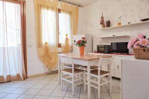 a kitchen with a table and chairs in a kitchen at Relaxing escape flat-Beahost in Rosapineta +15 photos