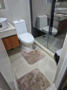 a bathroom with a toilet and a sink and mirrors at 3BR 70sqm Free internet, Penthouse unit in Ermita, Manila near US Embassy in Manila
