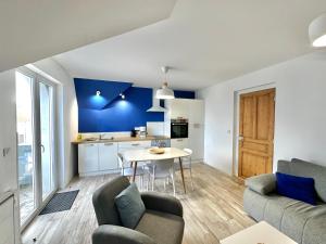 a living room with a couch and a table at Appartement 4 personnes à 100 m de la plage in Berck-sur-Mer +12 photos