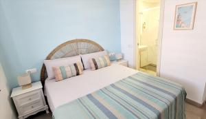a bedroom with a large bed and a bathroom at Blue Beach Apartment in Ifach +31 photos