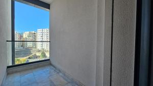 an empty room with a large window in a building at Tanger City Center Luxury 2BR AC WiFi Garage in Tangier