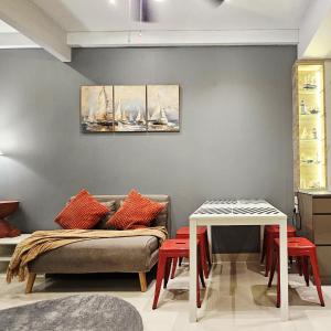 a living room with a couch and a table at Cozy Apartment with Sea View - One Residence in Pulau Sembakau Kecil