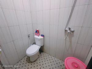 a bathroom with a toilet and a pink shower at Ubung Little House Denpasar in Sempidi