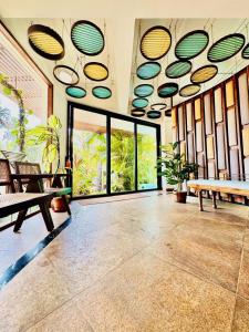 a room with a large room with large windows at HALF Hotel, Calangute in Calangute