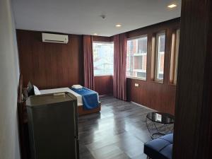 a room with a bedroom with a bed and a window at Blue Luxury Hotel & Spa in Da Nang