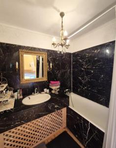 a black bathroom with a sink and a mirror at Escape to your dream Samui beach Villa ! in Ban Na We