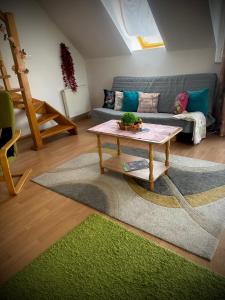 a living room with a couch and a coffee table at Tavaszmező in Pécs