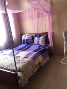 a bed with a canopy in a room at Holliday inn kigali in Kigali