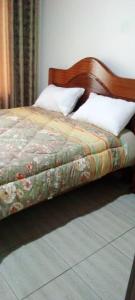 a bedroom with a bed with a wooden head board at Holliday inn kigali in Kigali