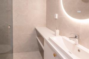 a white bathroom with a sink and a mirror at Villa Uleå - Villa Oulu in Oulu +19 photos