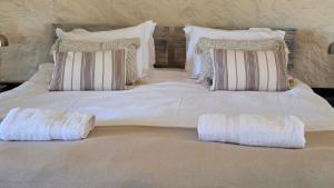 a large white bed with two pillows on it at Three Bridges B&B in Hoedspruit +32 photos
