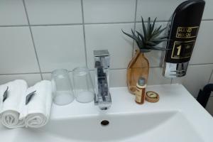 a white sink with toilet paper and a hair dryer at Altes Rathaus Kassel-Wolfhagen in Wolfhagen +30 photos